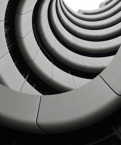 Abstract upward view of a modern circular architectural structure with repeating curves- Neutrinos