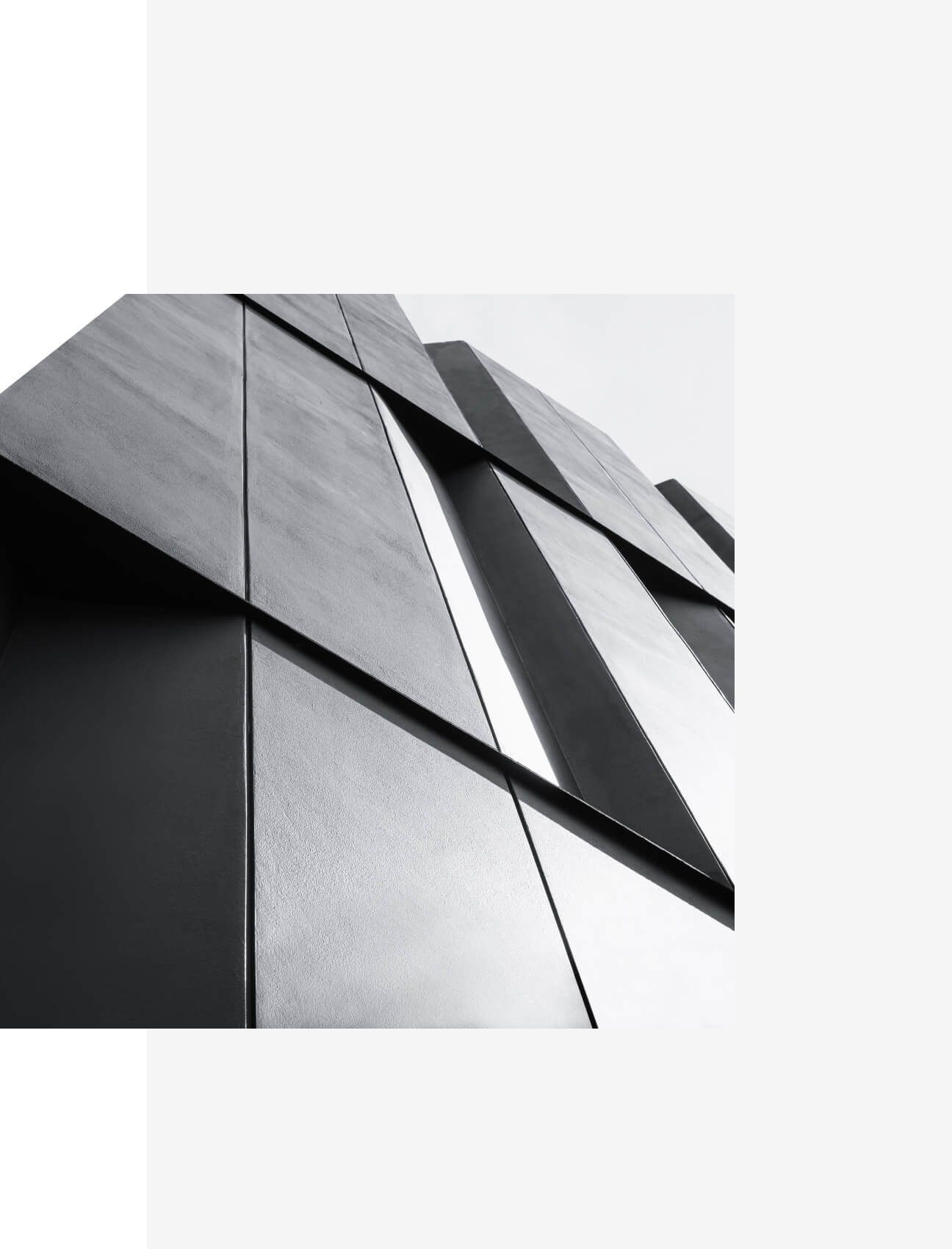 Upward view of modern geometric architecture with sharp black and white facade angles - Neutrinos
