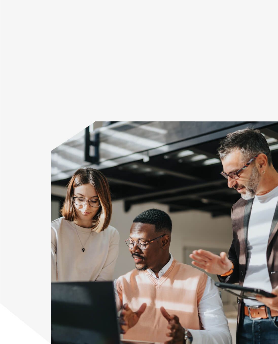 Business professionals collaborating around a laptop in a modern office setting - Neutrinos