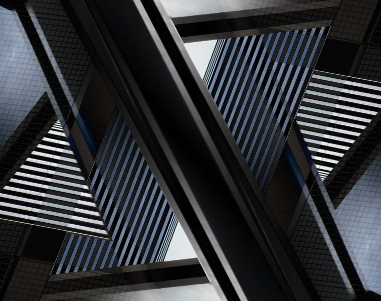 Abstract architectural pattern formed by reflections of modern glass skyscrapers with geometric lines and angles - Neutrinos